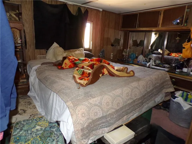 a bedroom with bed and window