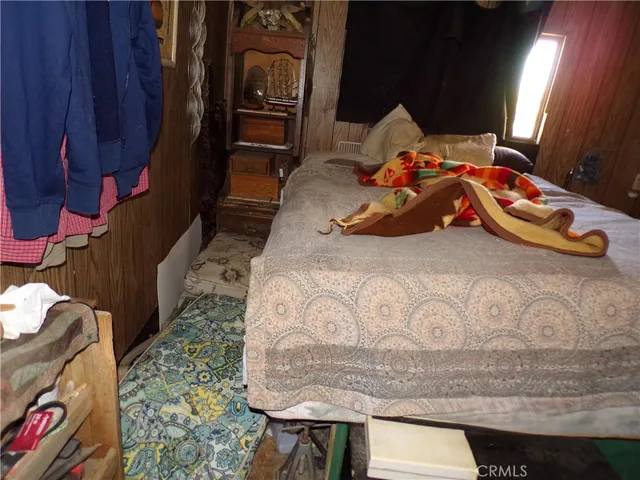 a room with a table chair and wooden floor