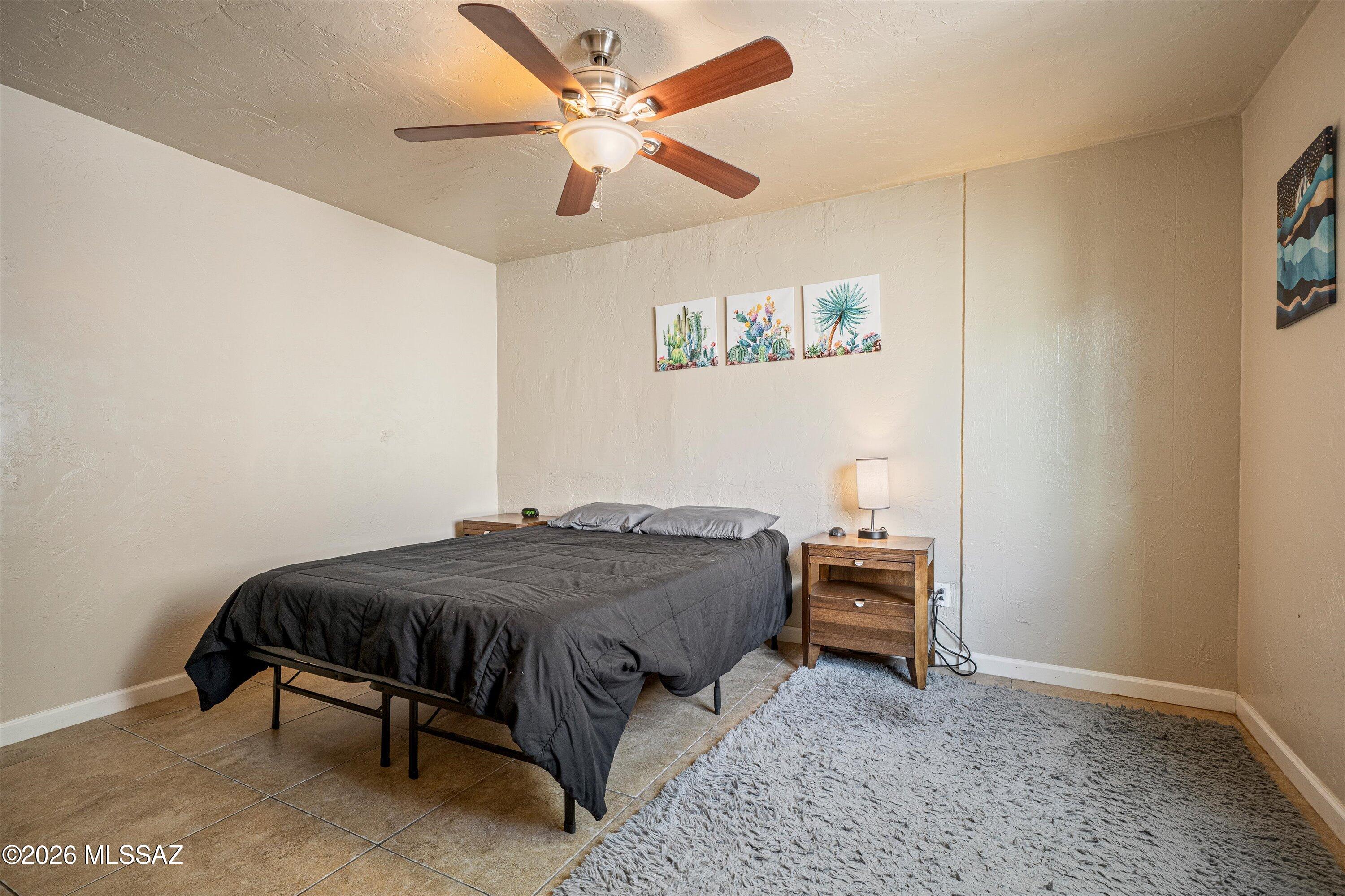 2619 East Prince Road Tucson, AZ 85716 - Photo 50 of 50 a bedroom with a bed and a chandelier