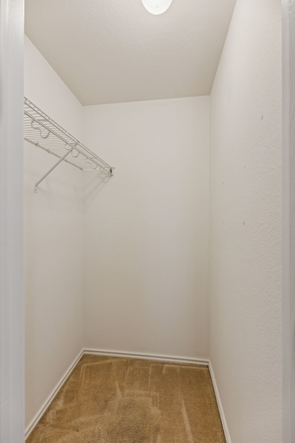 1148 Amberwood Loop Kyle, TX 78640 - Photo 17 of 22 a view of a room with racks on the wall