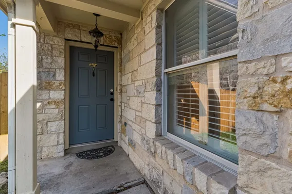 a view of house with a door and wooden door