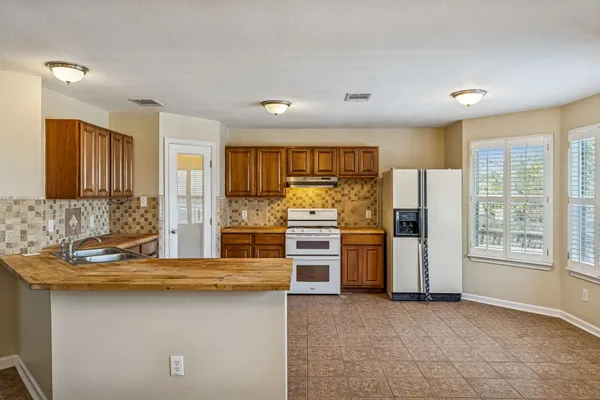 a kitchen with refrigerator and cabinets