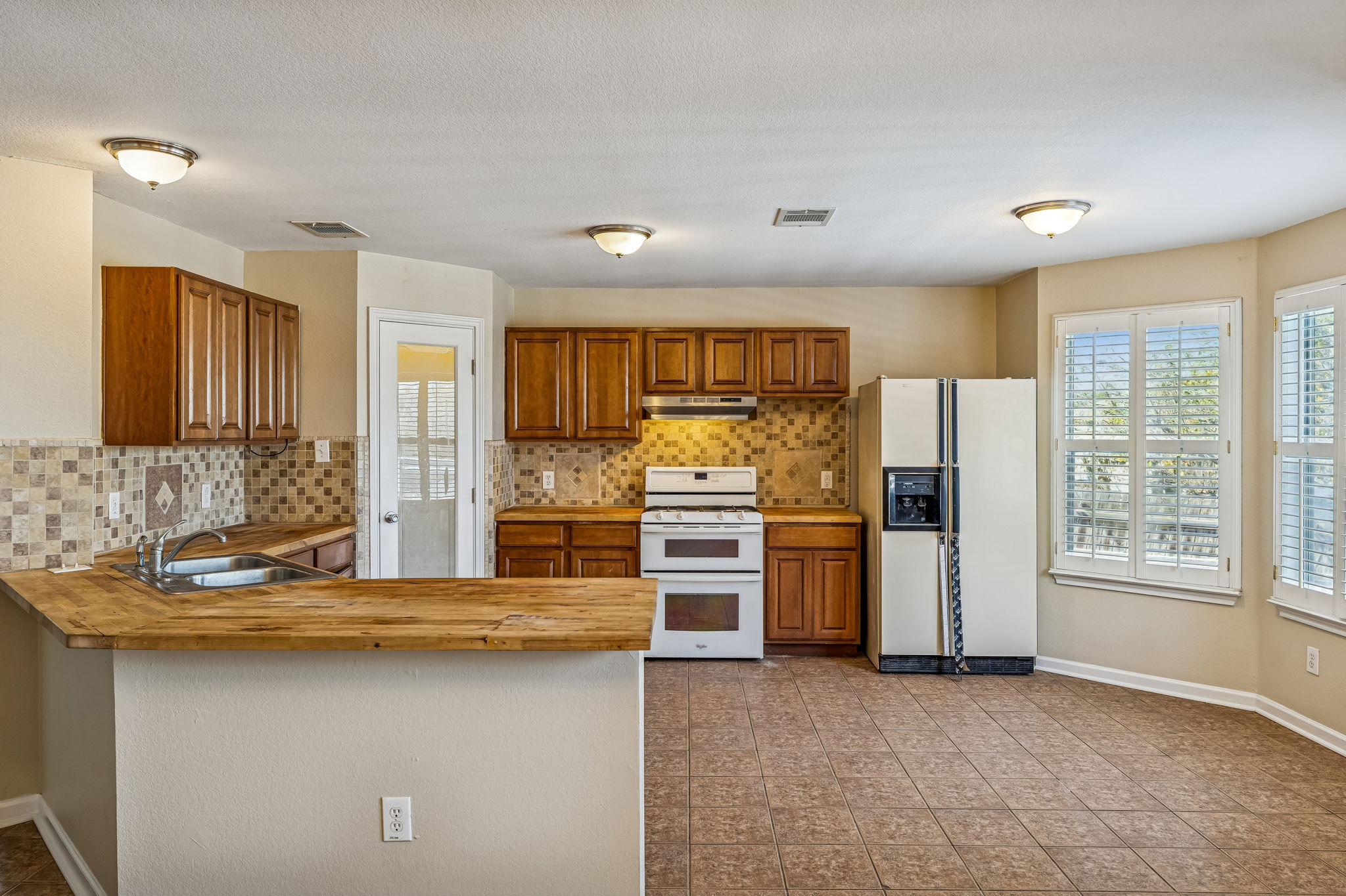 1148 Amberwood Loop Kyle, TX 78640 - Photo 8 of 22 a kitchen with refrigerator and cabinets
