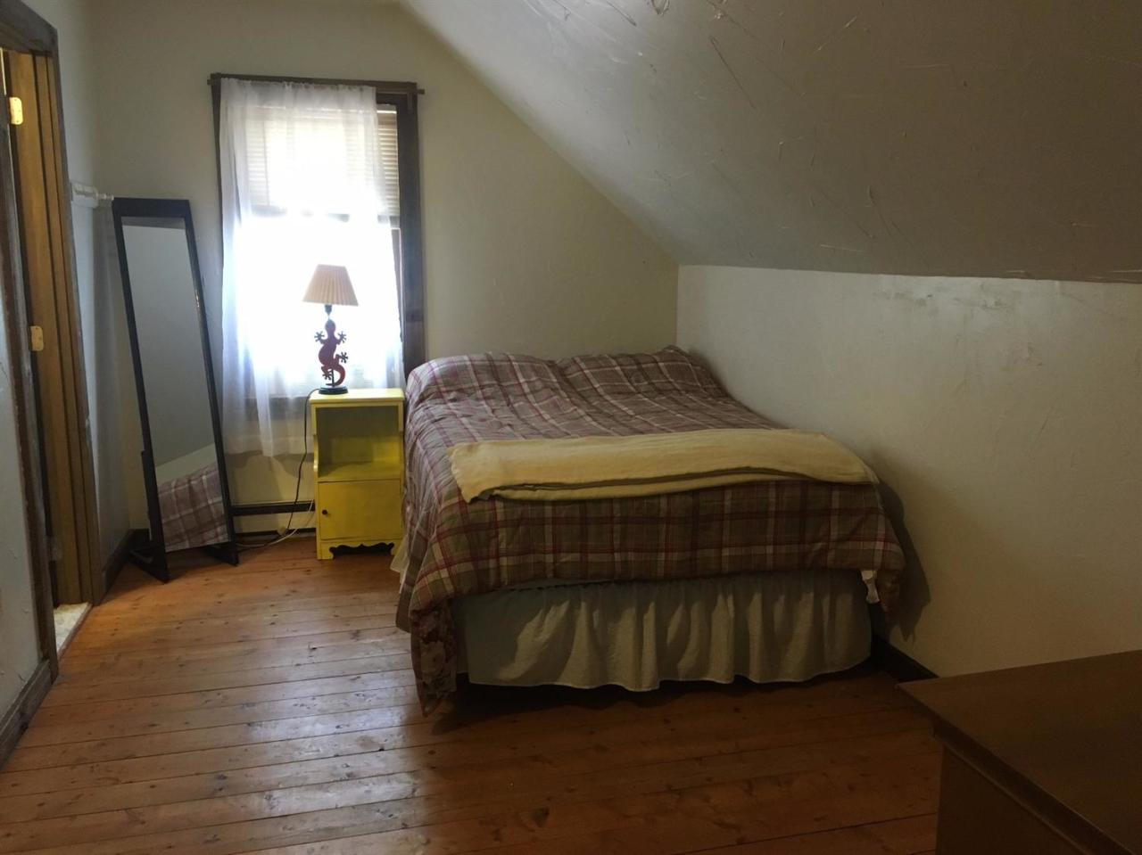 150 Gross Hill Road Wellfleet, MA 02667 - Photo 15 of 31 a bedroom with a bed and a mirror