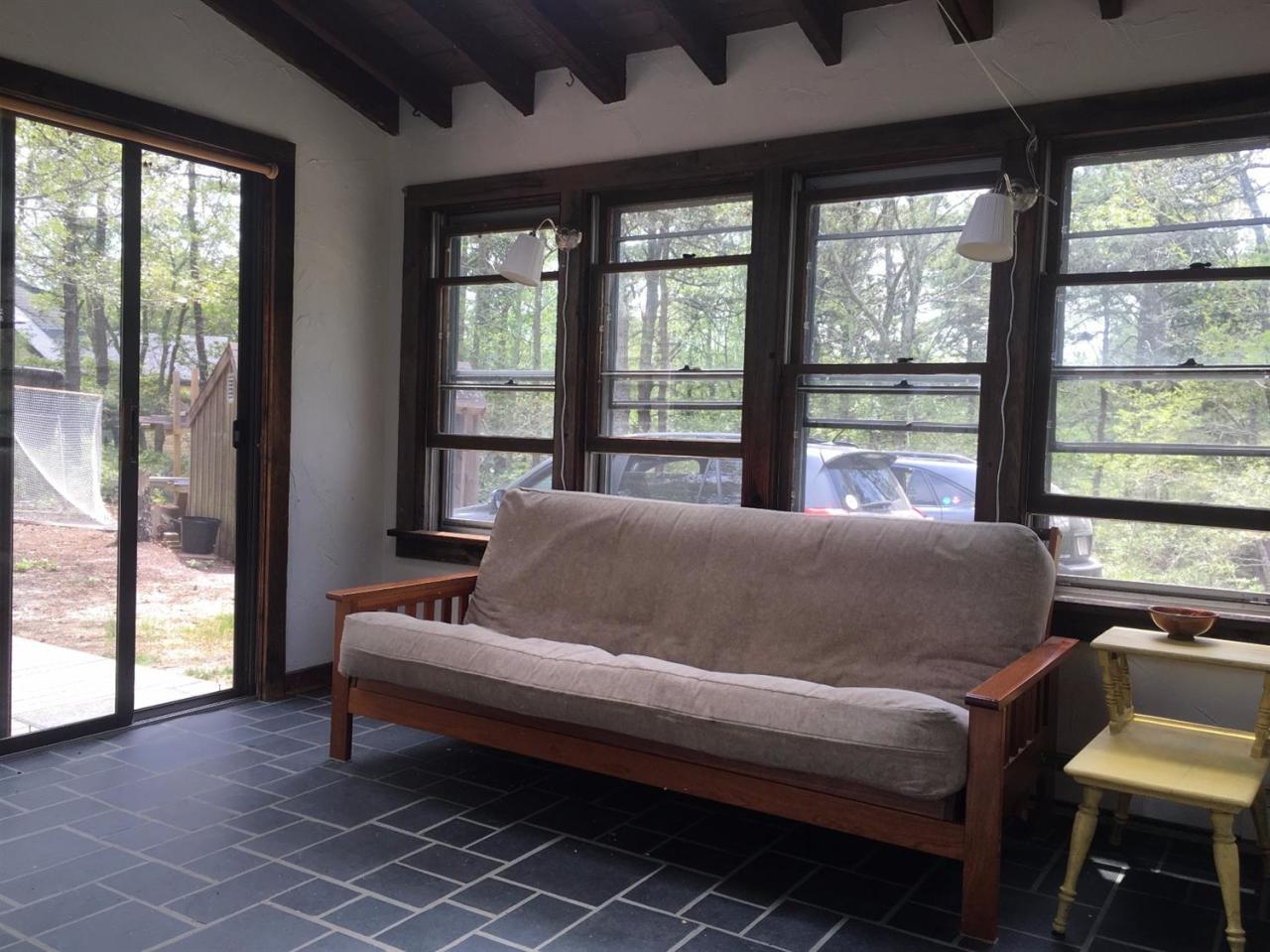 150 Gross Hill Road Wellfleet, MA 02667 - Photo 18 of 31 a living room with furniture and a floor to ceiling window