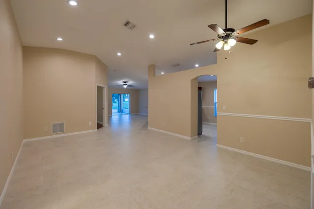 an empty room with fan and entrance