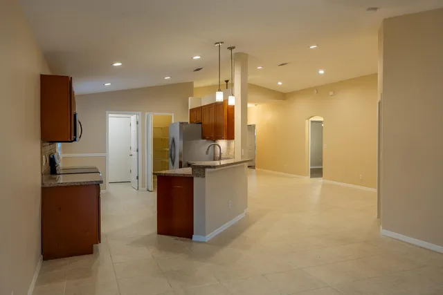 a view of kitchen with refrigerator and window
