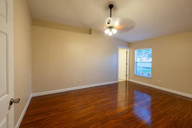 wooden floor in an empty room with a window