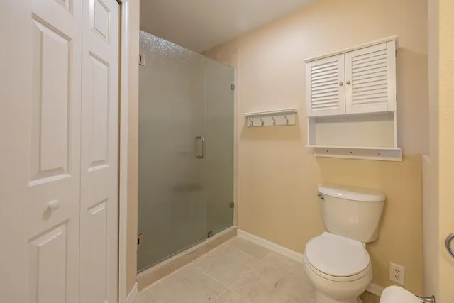 a white toilet sitting next to a bathroom sink