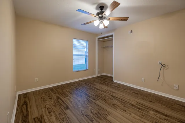 wooden floor in an empty room with a window