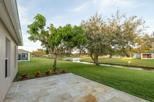 a backyard of a house with table and chairs