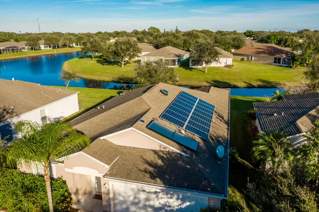 an aerial view of a house with a yard and potted plants