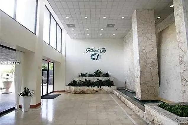 a view of a hallway with a dining table and chairs