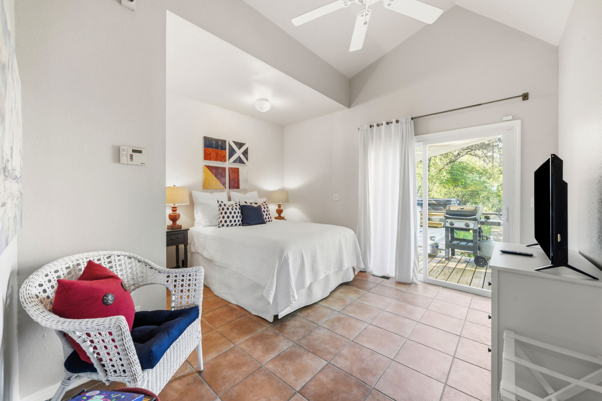 1715 Buffalo Gap Road Austin, TX 78734 - Photo 13 of 18 High vaulted ceilings and saltillo tile flooring define this inviting bedroom with outdoor access.