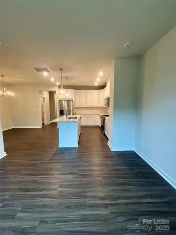 a view of a kitchen with wooden floor
