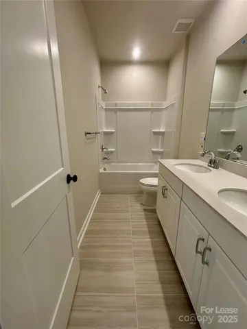 a bathroom with a tub sink shower and a mirror