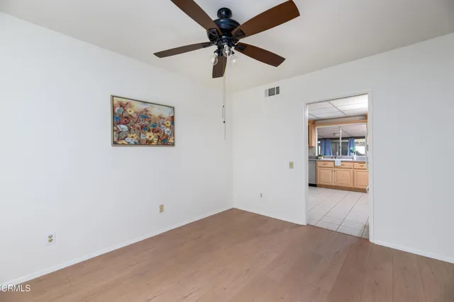 a view of a livingroom with a ceiling fan and window