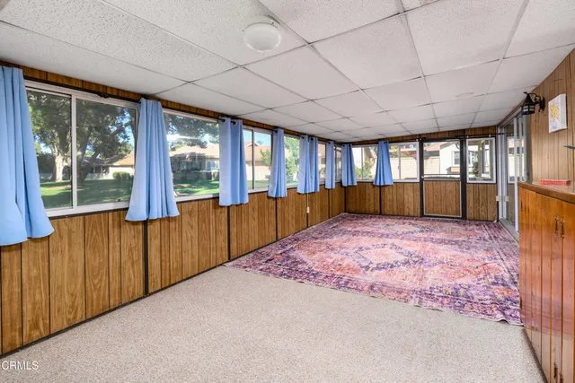 view of an empty room with wooden floor and a window