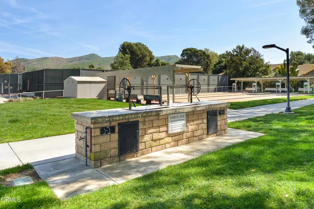 a view of a house with a yard and furniture