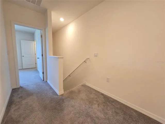 a view of a hallway with staircase