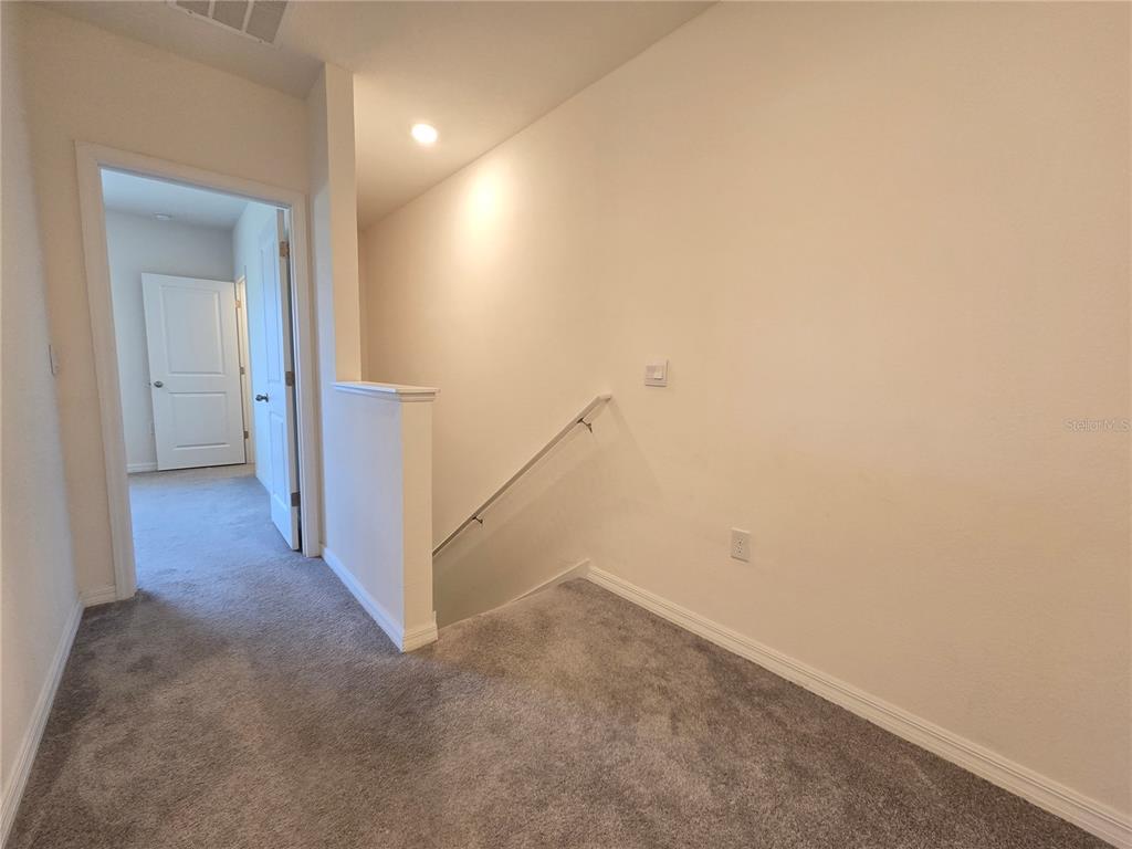 32803 Pez Landing Lane Wesley Chapel, FL 33543 - Photo 11 of 23 a view of a hallway with staircase