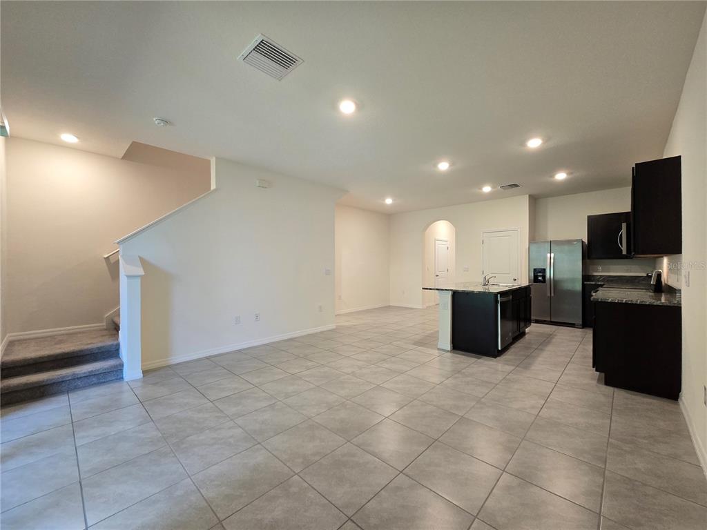 32803 Pez Landing Lane Wesley Chapel, FL 33543 - Photo 3 of 23 a view of a big room with kitchen dining table and chairs