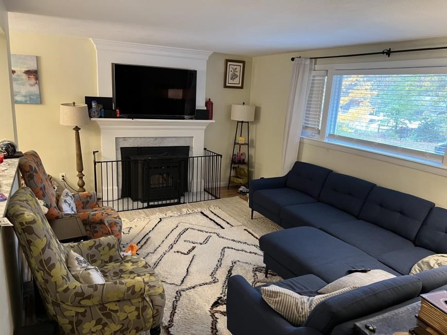 27 Burlington Road Bedford, MA 01730 - Photo 2 of 8 a living room with furniture a flat screen tv and a fireplace