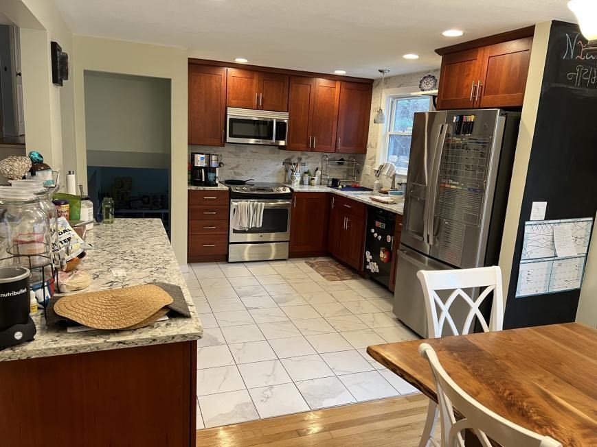 27 Burlington Road Bedford, MA 01730 - Photo 3 of 8 a kitchen with stainless steel appliances granite countertop a refrigerator a stove top oven and a sink