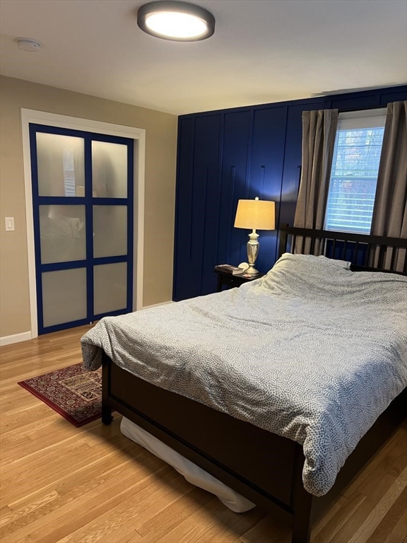 27 Burlington Road Bedford, MA 01730 - Photo 6 of 8 a bed sitting in a bedroom next to a window