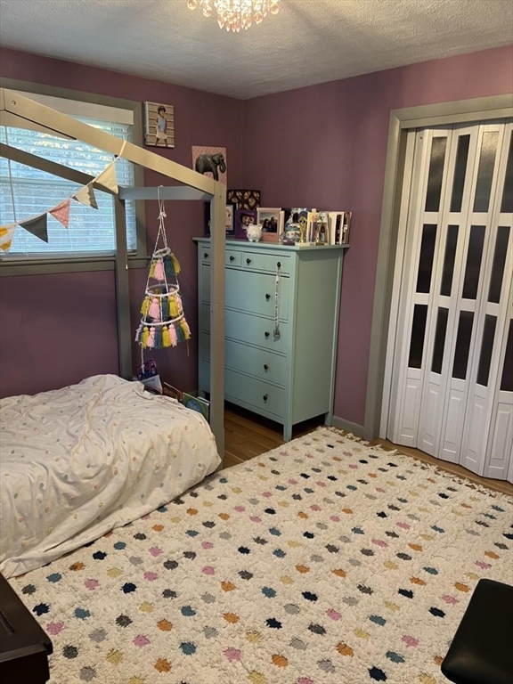 27 Burlington Road Bedford, MA 01730 - Photo 7 of 8 a bedroom with a bed and wooden floor