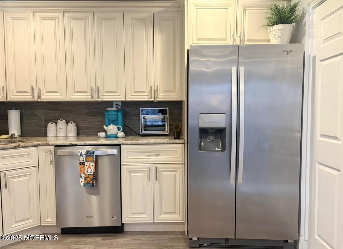 31 Kingsley Way Freehold, NJ 07728 - Photo 7 of 28 a kitchen with stainless steel appliances granite countertop a refrigerator and a white cabinets