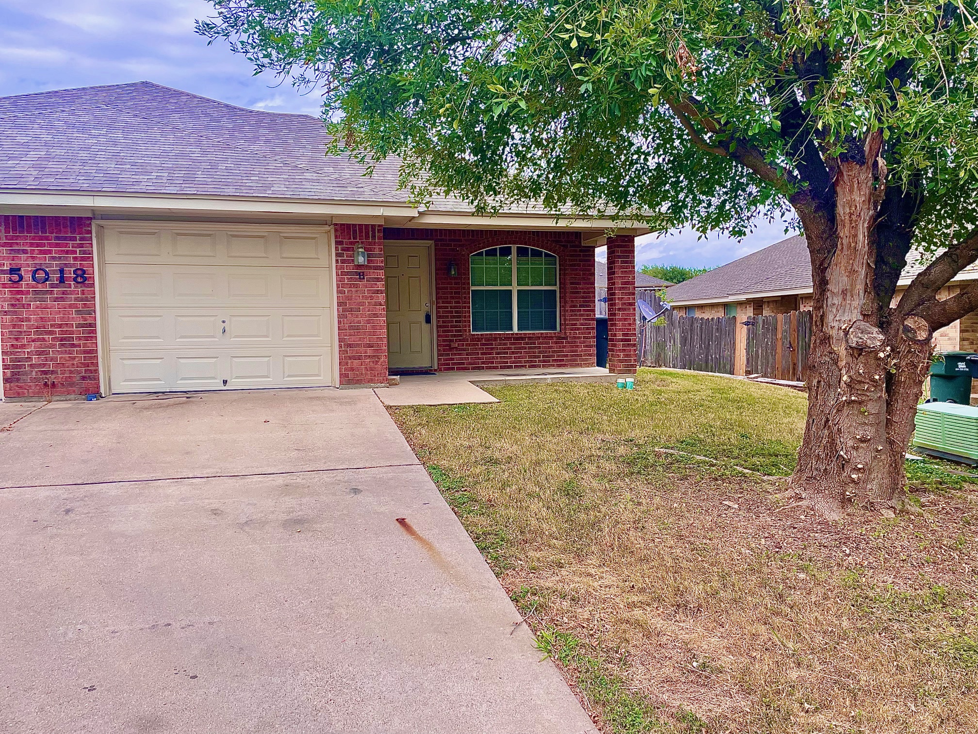 5018 205 Loop, Unit B Temple, TX 76502 - Photo 1 of 18 front view of a house with a tree