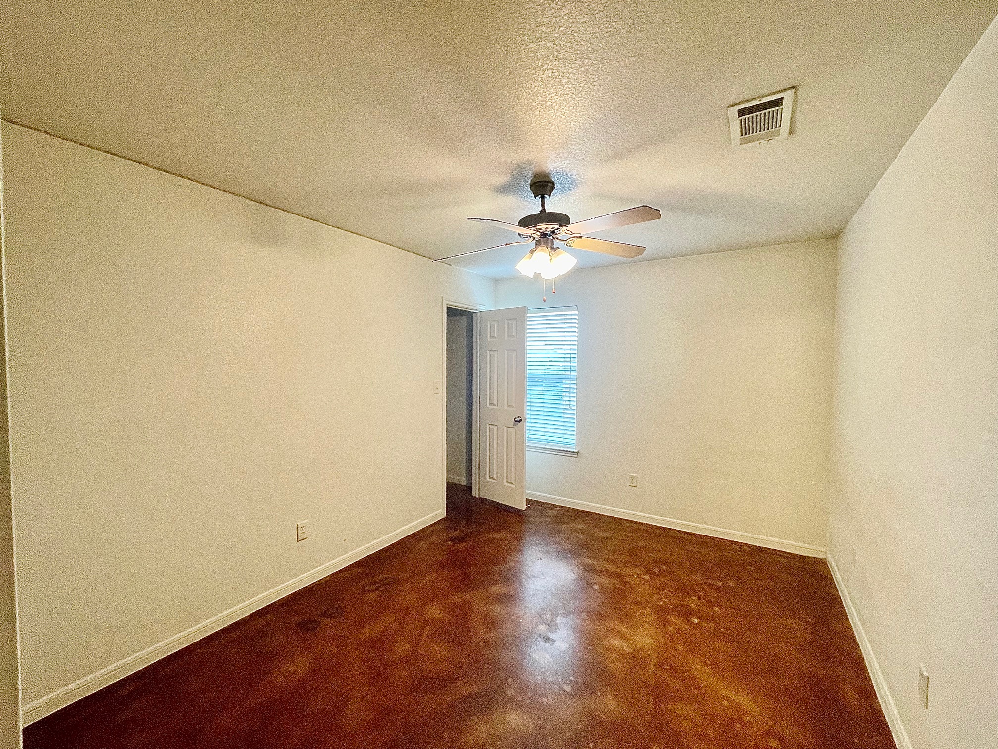 5018 205 Loop, Unit B Temple, TX 76502 - Photo 13 of 18 an empty room with a chandelier fan and windows