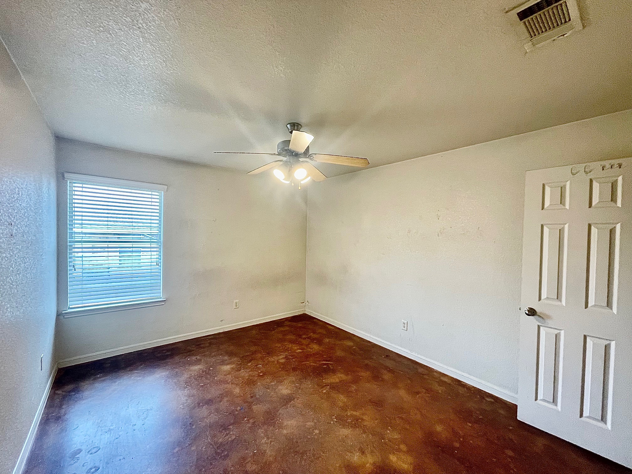 5018 205 Loop, Unit B Temple, TX 76502 - Photo 15 of 18 an empty room with a chandelier fan and windows