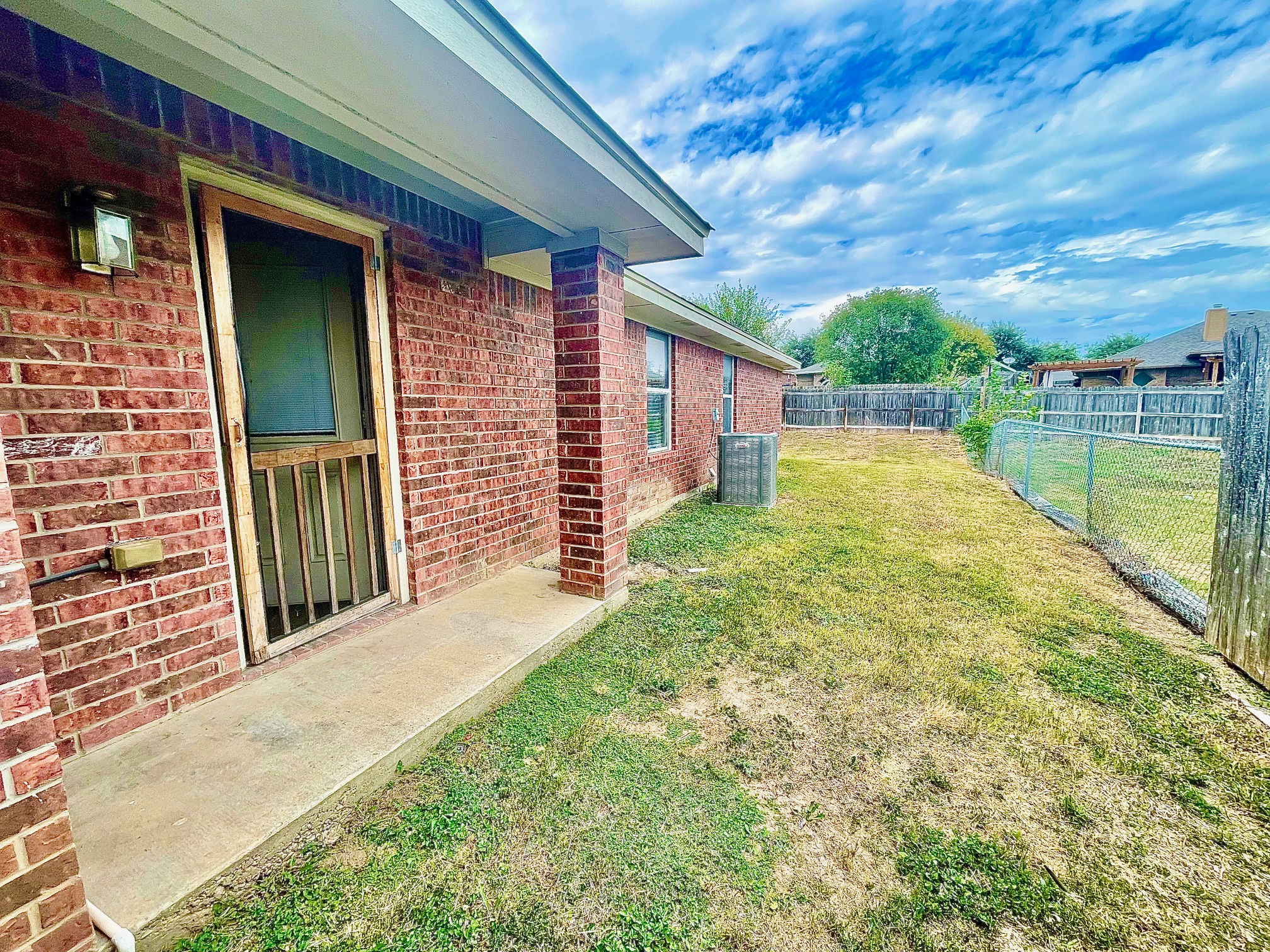 5018 205 Loop, Unit B Temple, TX 76502 - Photo 17 of 18 a view of a backyard with a garden