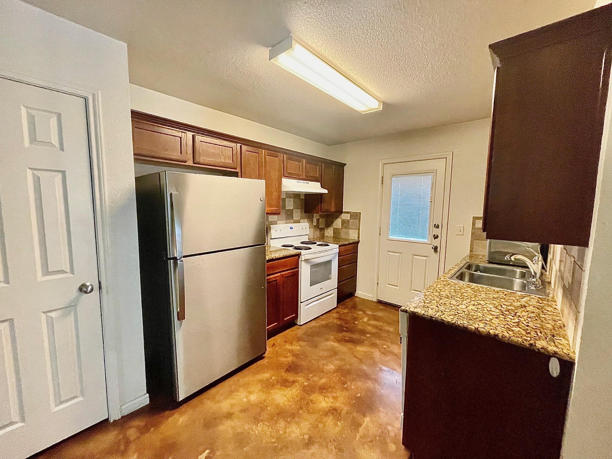 5018 205 Loop, Unit B Temple, TX 76502 - Photo 2 of 18 a kitchen with a refrigerator and a sink