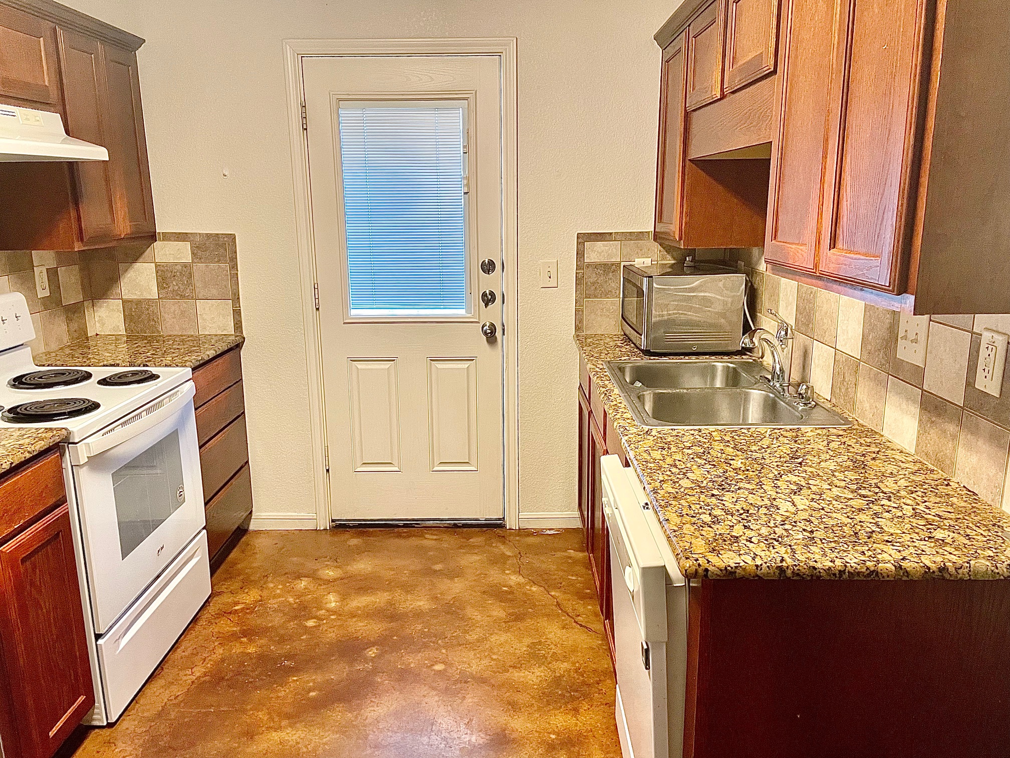 5018 205 Loop, Unit B Temple, TX 76502 - Photo 3 of 18 a kitchen with granite countertop a sink stove and refrigerator