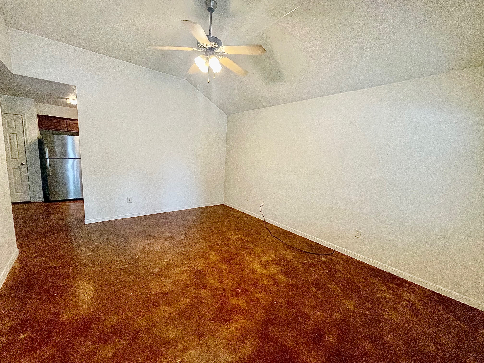 5018 205 Loop, Unit B Temple, TX 76502 - Photo 5 of 18 an empty room with a chandelier fan