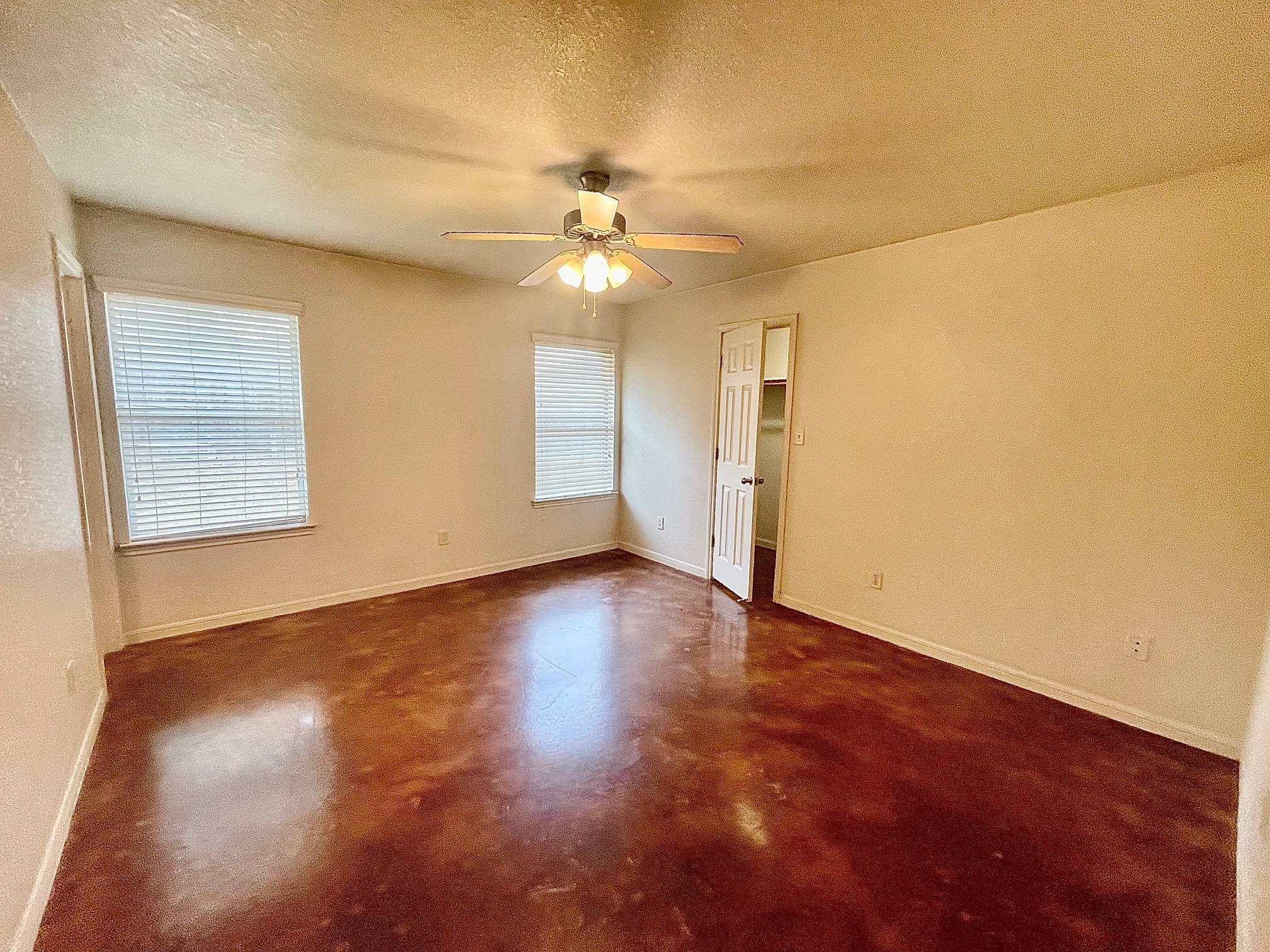 5018 205 Loop, Unit B Temple, TX 76502 - Photo 8 of 18 an empty room with wooden floor fan and windows