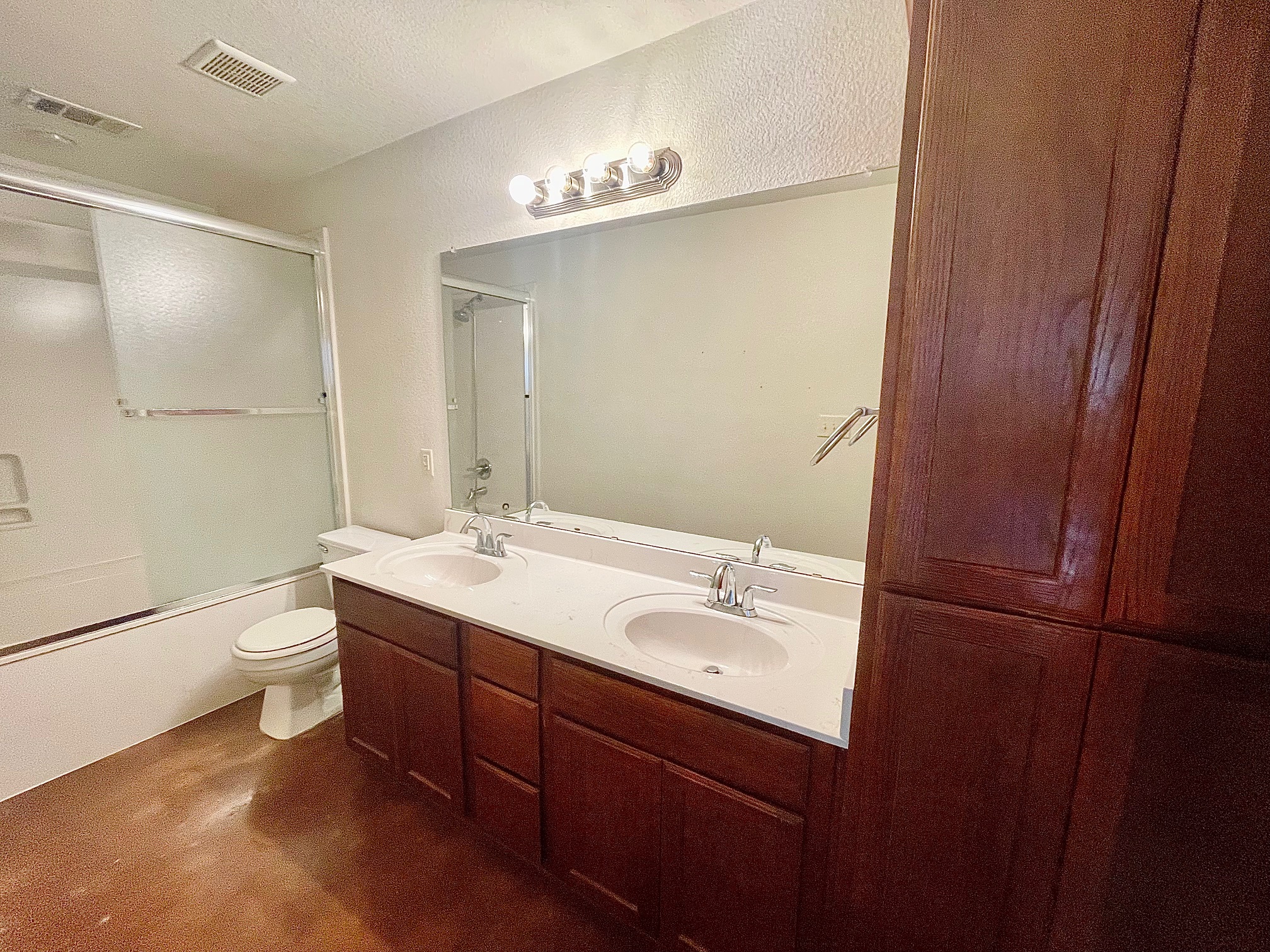 5018 205 Loop, Unit B Temple, TX 76502 - Photo 10 of 18 a bathroom with a double vanity sink toilet and mirror