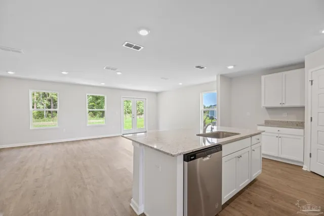 a kitchen with a sink stove and cabinets