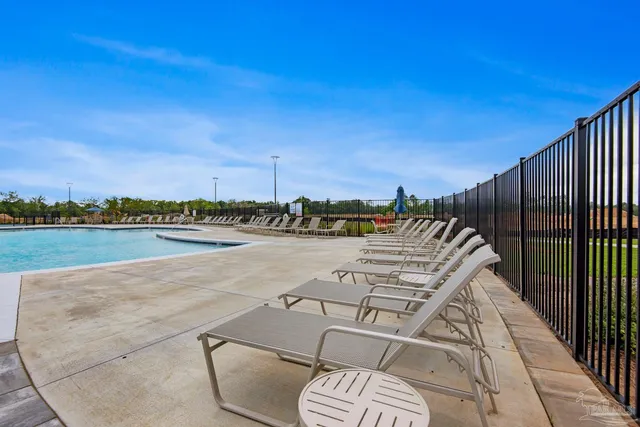 a view of swimming pool with outdoor seating and yard