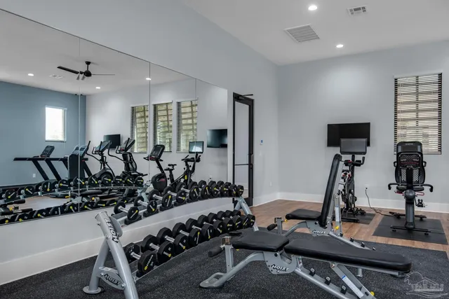 a room with gym equipment and windows