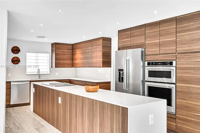 a kitchen with stainless steel appliances granite countertop lots of counter space and cabinets