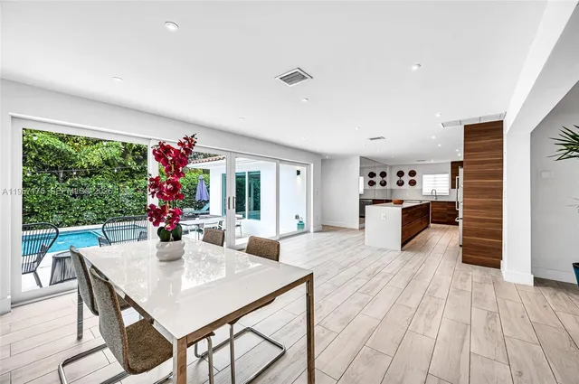 a living room with furniture a large window and a rug