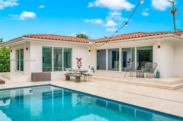 a kitchen with stainless steel appliances kitchen island granite countertop a sink and wooden cabinets