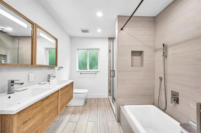 a bathroom with a sink a toilet and mirror