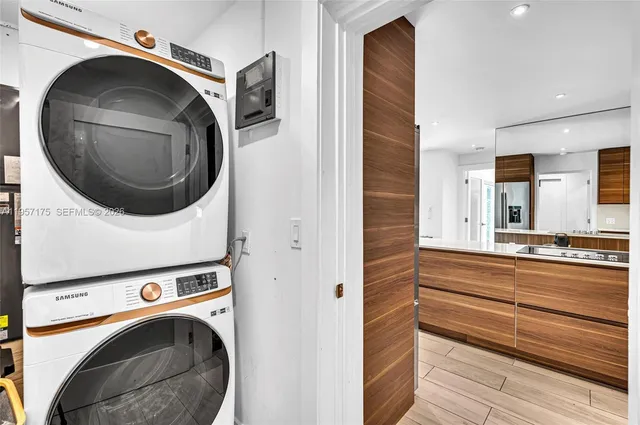 a room with a bed and large windows