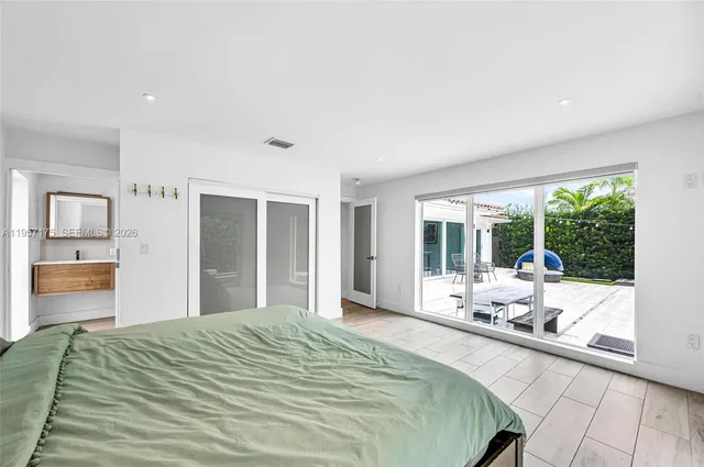 a bed sitting in a bedroom next to a window