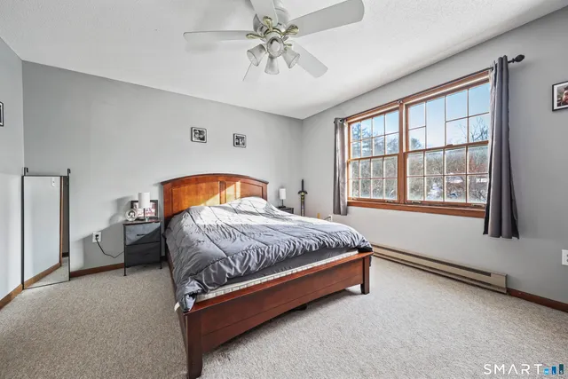 a spacious bedroom with a bed and a window